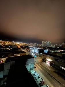 a city at night with cars parked on a street at Orella 6p Apartament in Antofagasta