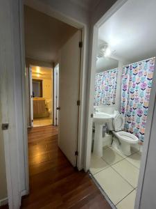 a bathroom with a toilet and a sink at Orella 6p Apartament in Antofagasta +22 photos