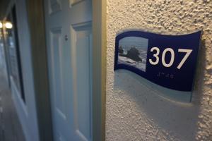 a clock on a wall next to a door at Crescent Bay Inn in Laguna Beach