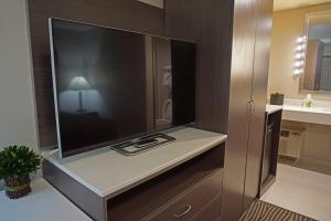 a large flat screen tv on a cabinet in a bathroom at Crescent Bay Inn in Laguna Beach +37 photos