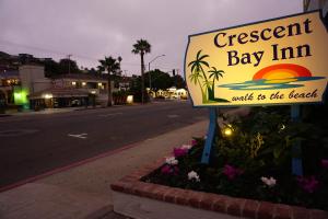 a sign for a restaurant bay inn walks to the beach at Crescent Bay Inn in Laguna Beach