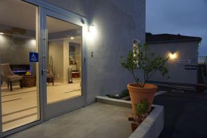 a sliding glass door to a patio with a potted plant at Crescent Bay Inn in Laguna Beach