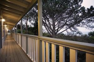 a walkway on a house with a tree in the background at Crescent Bay Inn in Laguna Beach