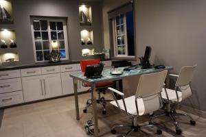 a kitchen with a desk with a laptop and chairs at Crescent Bay Inn in Laguna Beach