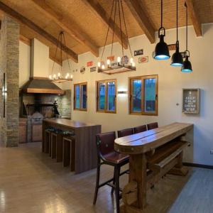 a large kitchen with a wooden table and a counter at Pucon villarrica in Pucón