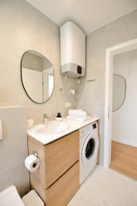 a bathroom with a sink and a washing machine at Apartment Luka in Zadar
