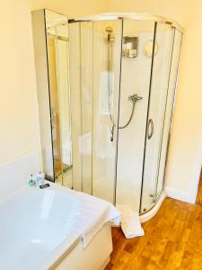 a bathroom with a shower and a white sink at Skipton Cottage in Skipton