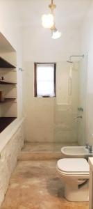 a white bathroom with a toilet and a sink at CASA ATELIER in Tilcara