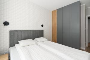 a bedroom with a bed with two pillows on it at Bookowska Apartments in Poznań