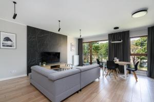 a living room with a couch and a table at Bookowska Apartments in Poznań