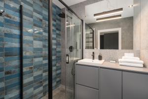 a bathroom with a sink and a shower at Bookowska Apartments in Poznań +42 photos