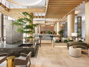 a lobby with couches and tables and plants at Fairmont Century Plaza Los Angeles in Los Angeles