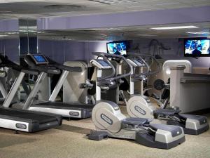 a gym with a bunch of tread machines and televisions at Fairmont Dallas in Dallas
