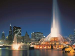 a large fountain in front of a city at night at Fairmont Chicago Millennium Park in Chicago