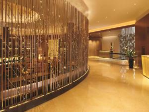 a lobby with a large wall of gold sticks at Fairmont Chicago Millennium Park in Chicago
