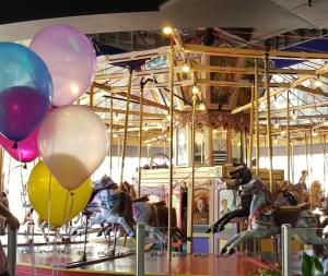 a group of balloons on a carousel at Acaill Accommodation Esplanade Living Self Check-In Self Check-Out in Adelaide