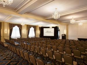 an empty room with a stage and chairs at Fairmont Le Manoir Richelieu in La Malbaie