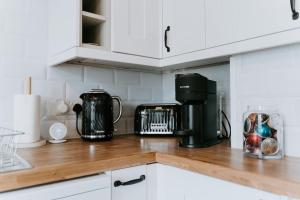 a kitchen counter with a coffee maker on a wooden counter top at Bluebell cottage Branston Lincoln in Branston