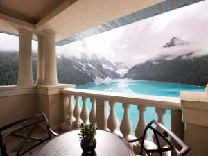 a balcony with a view of a blue lake at Fairmont Château Lake Louise in Lake Louise