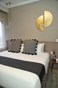 1 dormitorio con 1 cama blanca grande y 2 almohadas en Agata Hotel Boutique & Spa en Ciudad de México