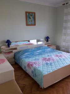 a bedroom with a bed and two dressers at Apartment Kampor 4972b in Kampor
