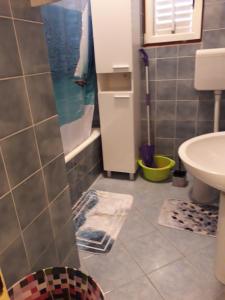a bathroom with a shower and a sink and a toilet at Apartment Kampor 4972b in Kampor