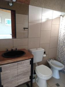 a bathroom with a toilet and a sink at Balcón de la montaña in Santa Rosa de Calamuchita