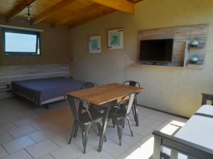 a room with a table and a bed and a tv at Balcón de la montaña in Santa Rosa de Calamuchita
