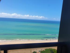 an ocean view from a window of a beach at Flat Beach Class Internacional in Recife