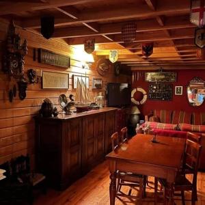 a dining room with a table and a bar at Hotel Antigua Casona Patagonia in Futaleufú