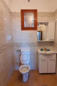 a bathroom with a toilet and a sink at Secluded holiday house Prigradica, Korcula - 19956 in Blato