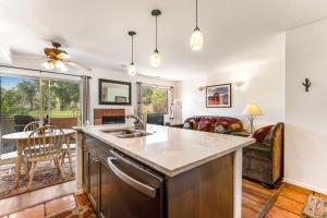 a kitchen with a sink and a living room at Solano Vallejo 3288 in Moab