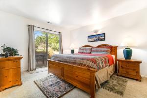 a bedroom with a large bed and a balcony at Solano Vallejo 3288 in Moab