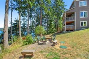 a backyard with a fire pit and a house at Brighton Beach House in Port Hadlock