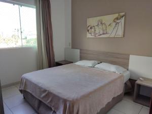 a bedroom with a bed and a painting on the wall at Riviera Park in Caldas Novas +37 photos
