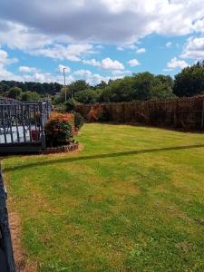 a yard with a fence and a grass field at Mary's place in Castlewellan