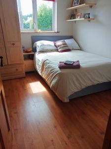 a bedroom with a bed and a wooden floor at Mary's place in Castlewellan