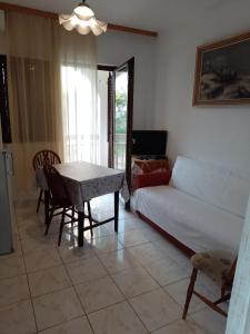 a living room with a white couch and a table at Apartments with a parking space Gradac, Makarska - 6820 in Gradac