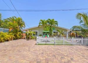 a white fence in front of a house at The Salty Cove IRB in Clearwater Beach
