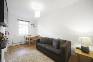 a living room with a couch and a table at Modern Deluxe Apartment London Camberwell Denmark in London