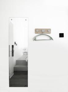 a bathroom with a mirror and a sink in a room at SYRI Boutique Guesthouse Restaurant & Cafe in Vientiane +127 photos