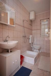 a bathroom with a sink and a toilet at Apartments with a parking space Sveti Petar, Biograd - 3251 in Sveti Filip i Jakov