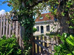 een houten hek met een huis erachter bij Beautiful villa in central France in La Chapelle-Blanche-Saint-Martin