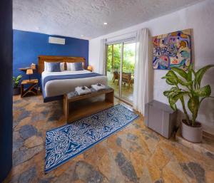 a bedroom with a bed and a potted plant at Blue Apple Beach in Tierra Bomba