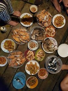 a table with many plates of food on it at Antonio's Ko Yao Noi in Ko Yao Noi