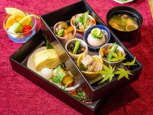 a box filled with different types of food on a table at ホテルアベストグランデ京都清水 in Kyoto
