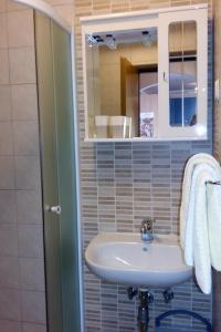 a bathroom with a sink and a mirror at Apartments with parking space Kraj, Opatija - 7794 in Kraj +23 photos