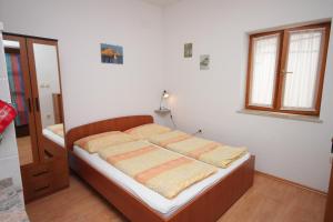 a bedroom with a bed in a room at Studio Kraj 7794b in Kraj