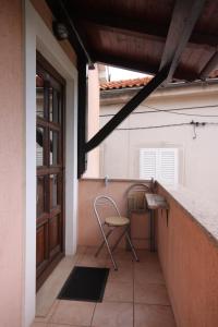a chair sitting on a porch next to a door at Studio Kraj 7794b in Kraj +11 photos