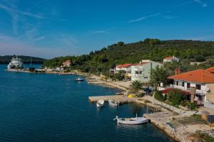 a group of boats docked in a body of water at Apartments with a parking space Brbinj, Dugi otok - 8160 in Brbinj